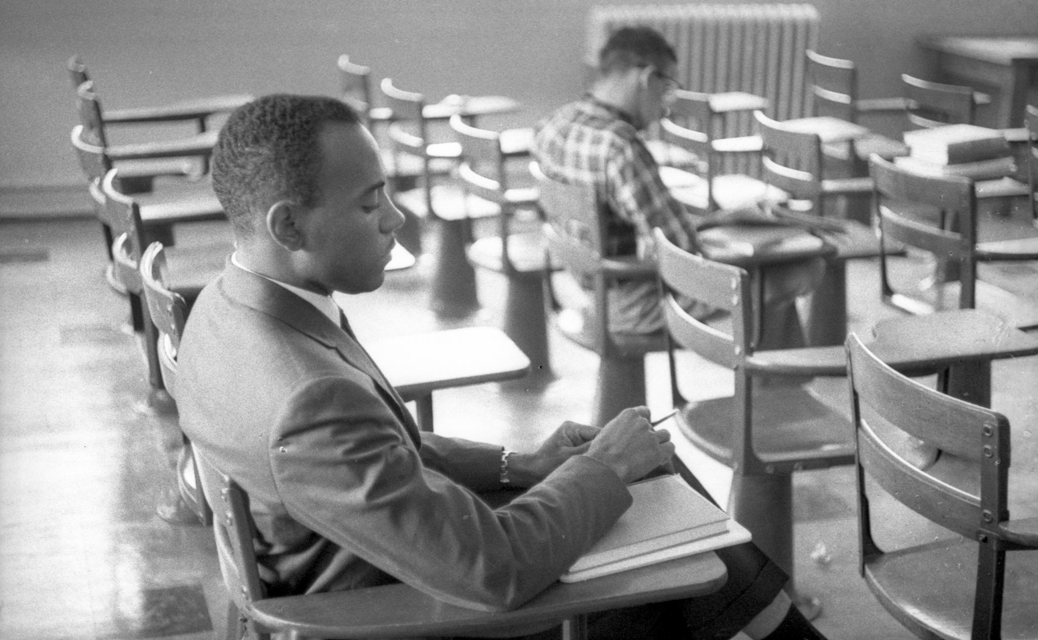 James Meredith seated in a classroom. Copyright of the Ed Meek Collection at the University of Mississippi: Integration of 1962. Joint ownership between Ed Meek, The University of Mississippi, The School of Journalism and New Media and The Department of Archives and Special Collections. 
